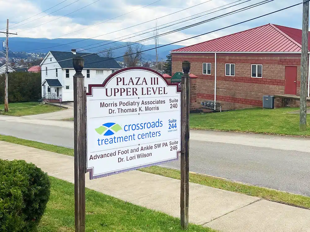 Roadside sign showing Crossroads Treatment Centers location