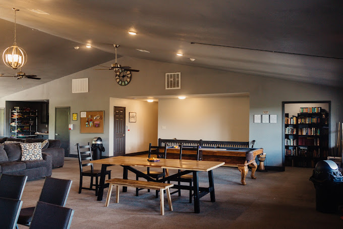 Lounge with seating, game tables, and bookshelf