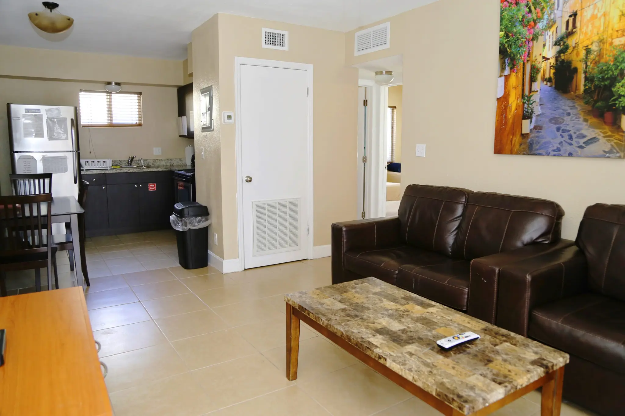 Kitchen with granite countertops, fridge, and stove