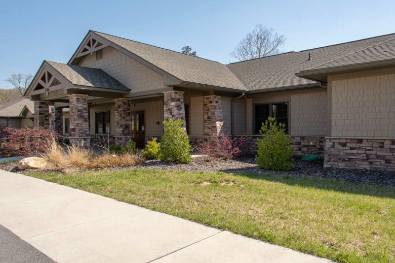 Stone-accented residential facility with front lawn