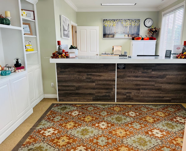 Well-lit reception area with a clean, modern design with wooden accents.