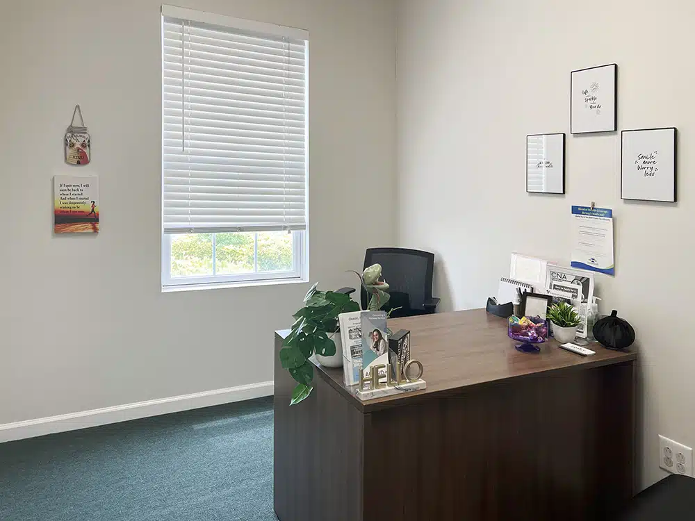 Small office with desk, chair, and window lighting