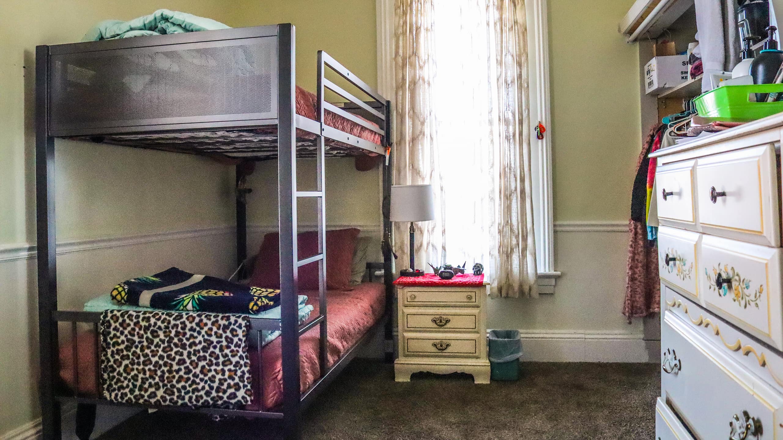 Shared bedroom with bunk beds and floral dresser