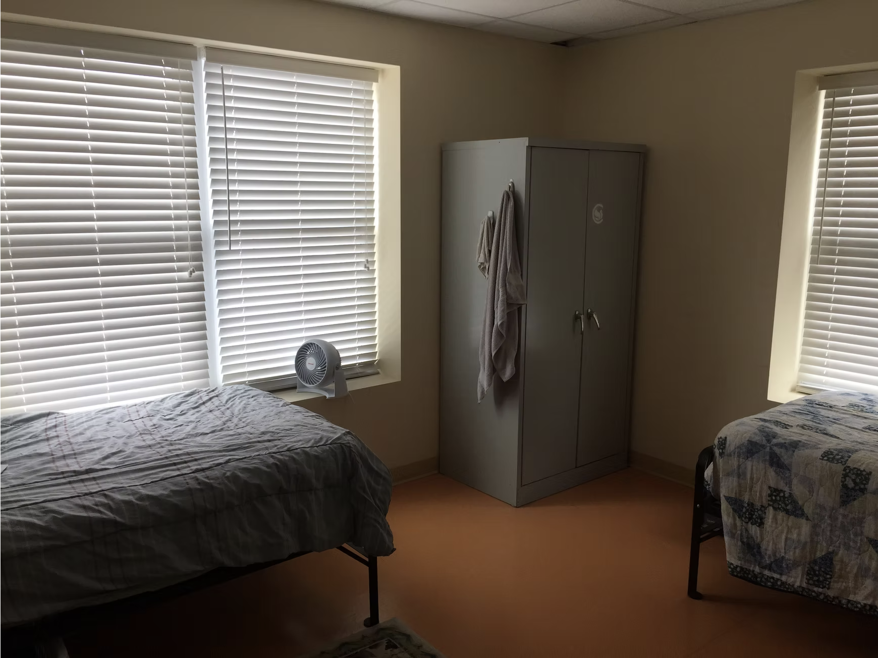 Private patient bedroom with a colorful quilt at Serenity Place in Dover
