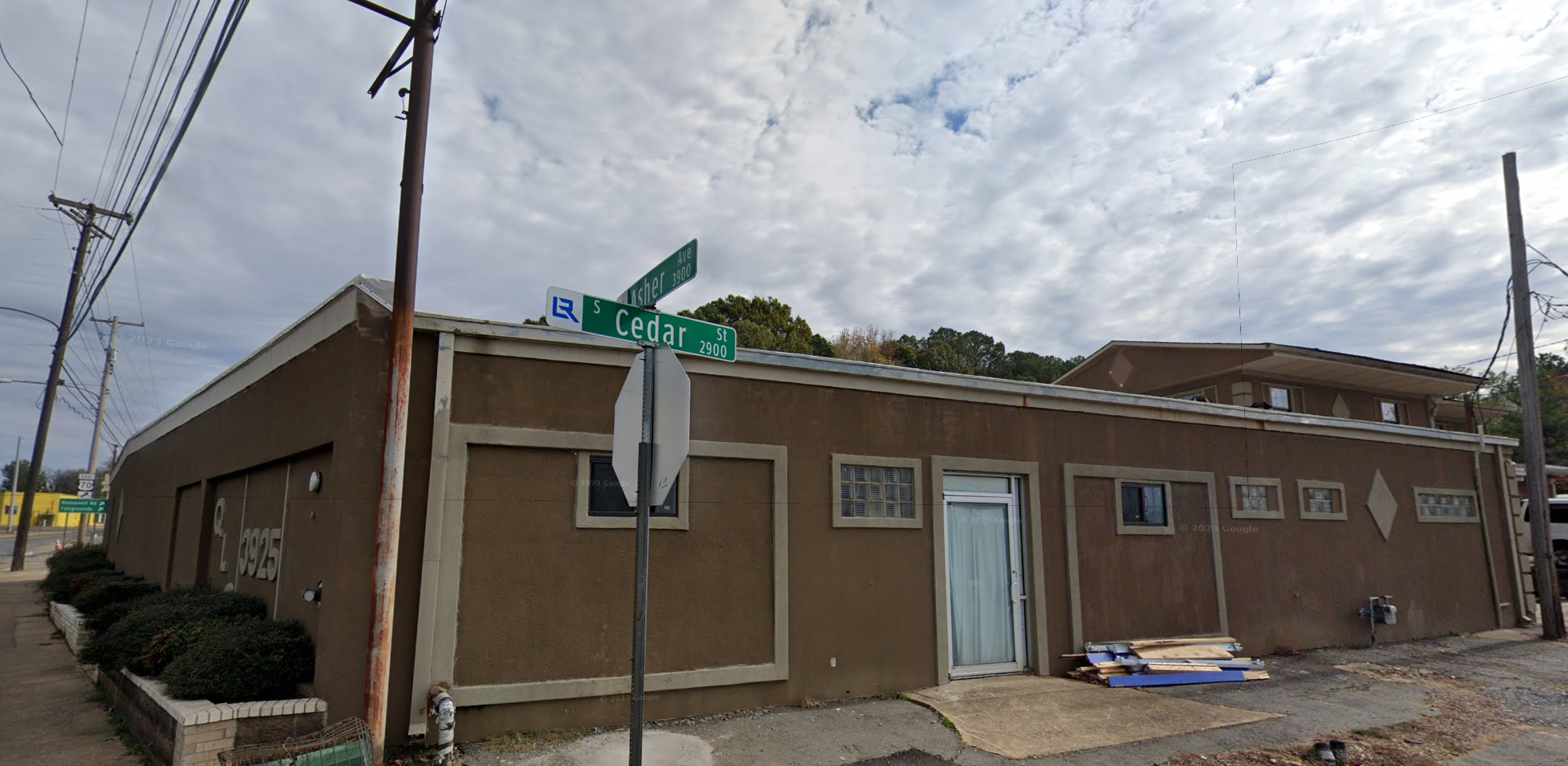 The entrance to Quality Living Center Inc., a brown building with a glass door located at the intersection of Asher Ave and Cedar St in Little Rock.