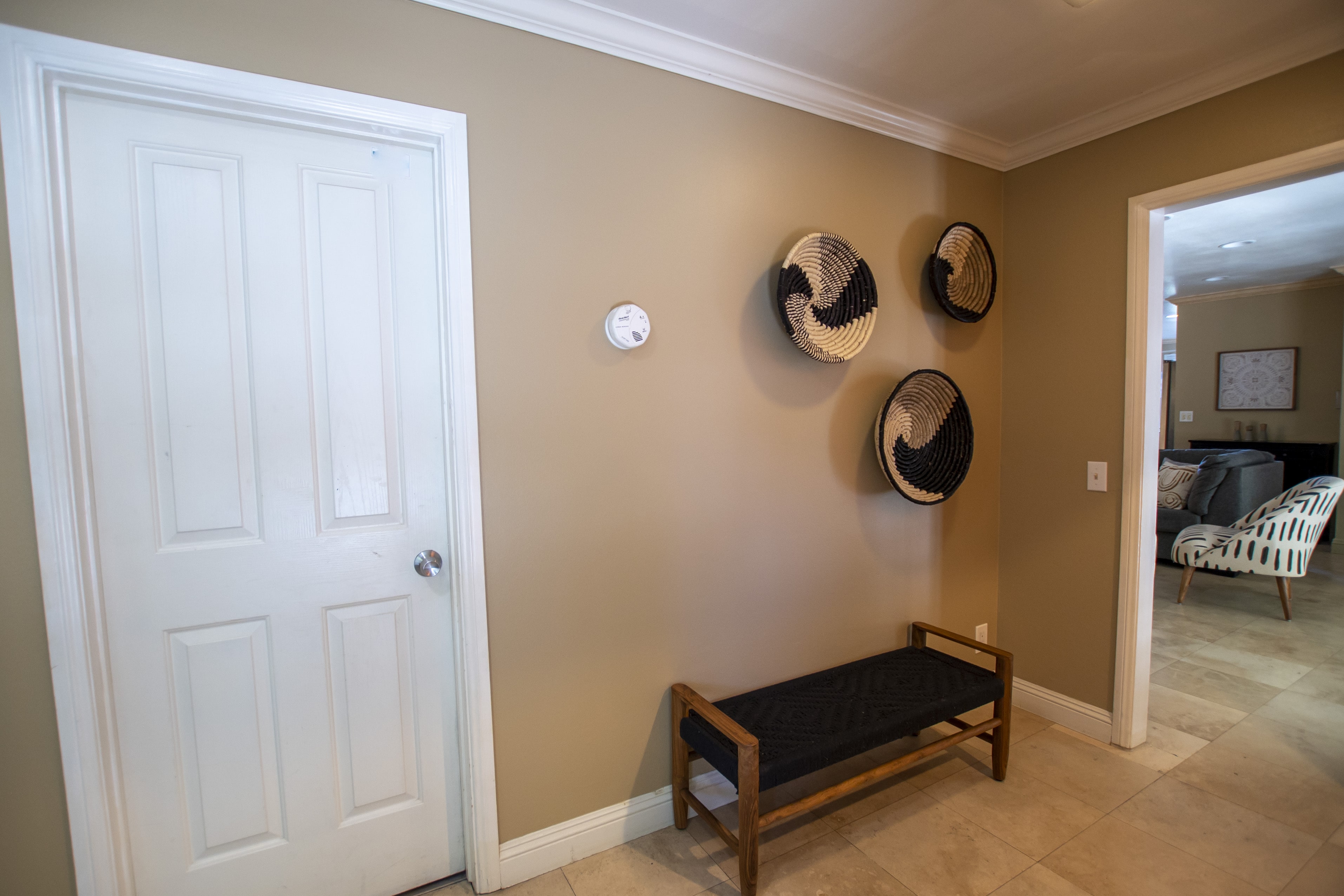 Hall bench under three woven wall baskets