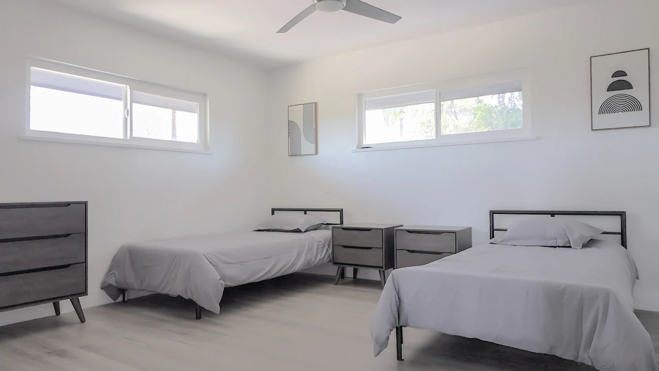 Shared bedroom with twin beds and dressers