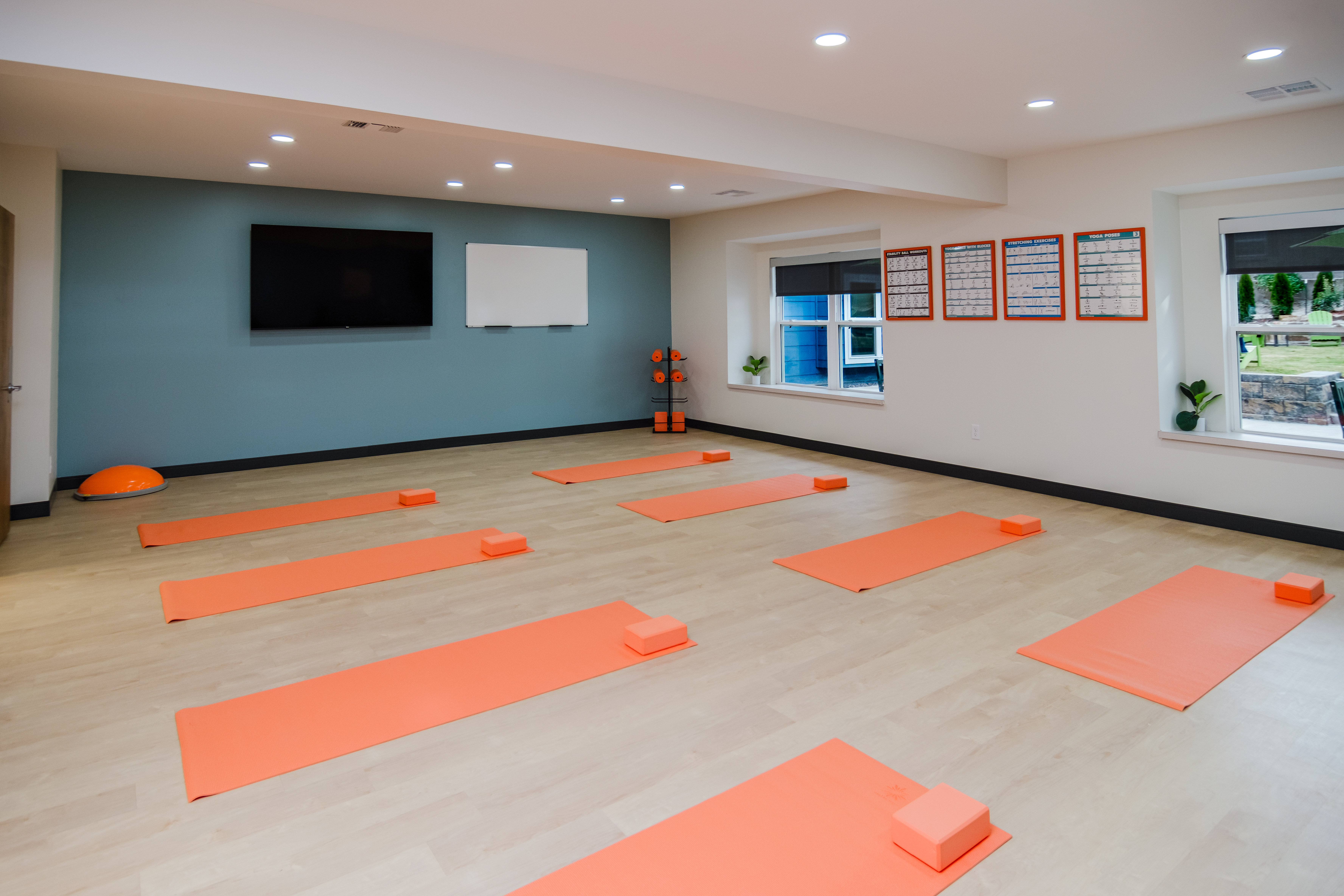 Yoga room with mats arranged for group sessions.