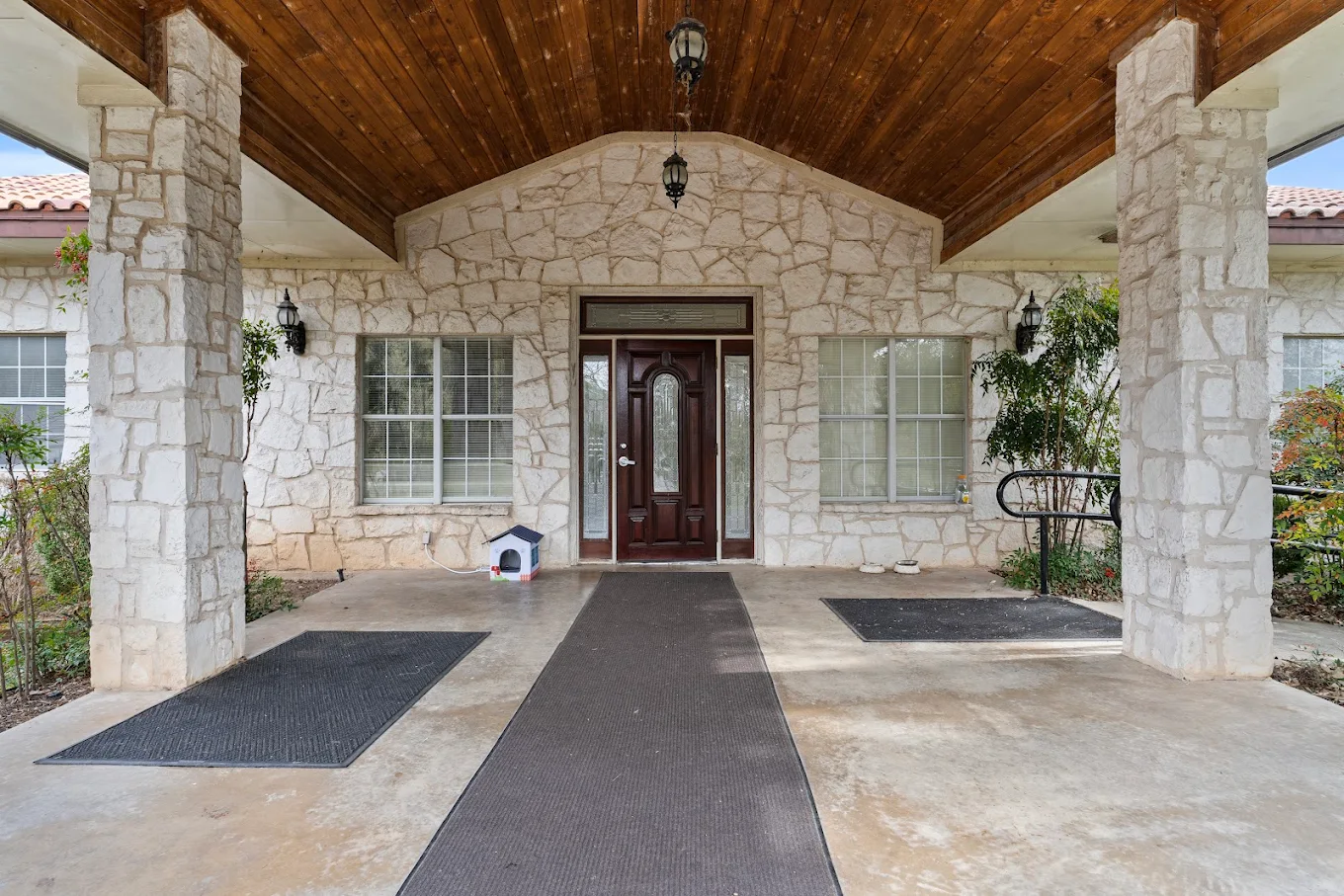 Stone building entrance with covered walkway and front door