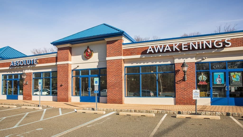 Front view of Absolute Awakenings rehab center with blue accents
