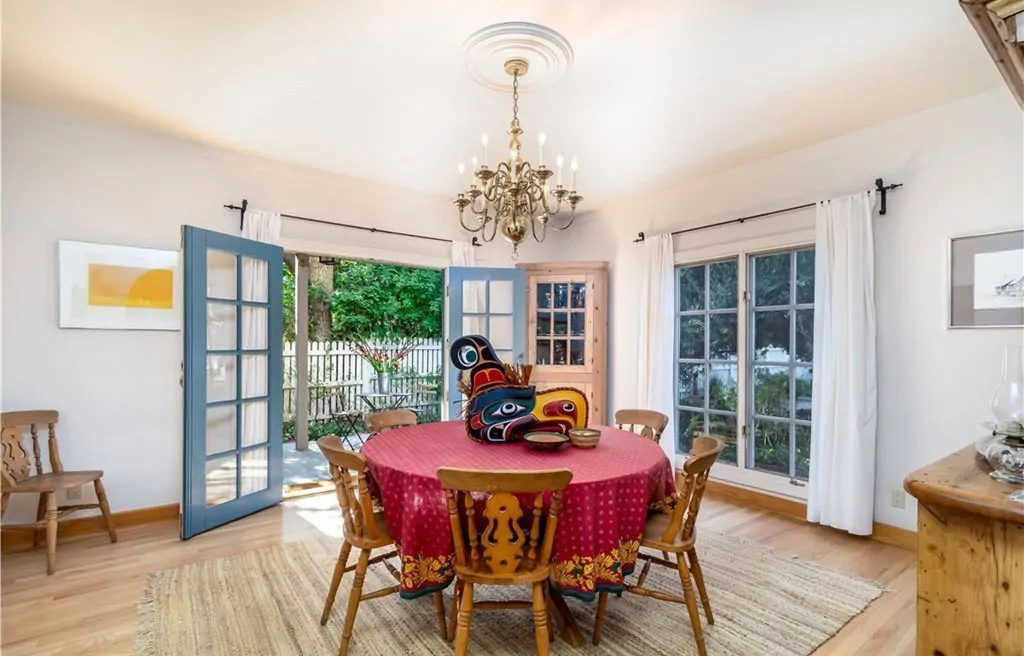 Dining room with round table and garden-facing French doors