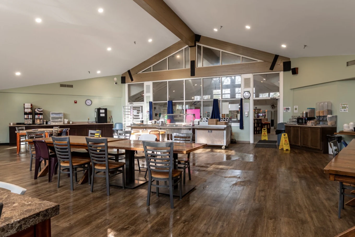 Spacious dining area with tables, chairs, and serving counter