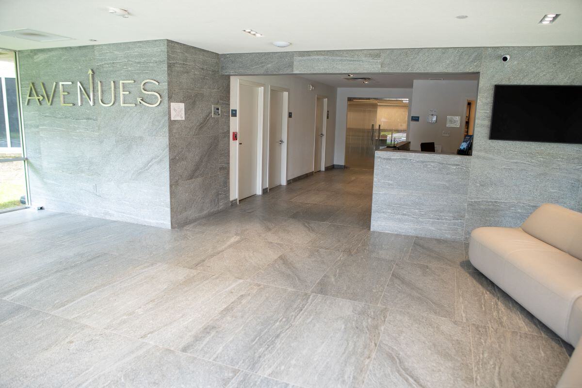 Modern lobby with gray tile floors and seating area