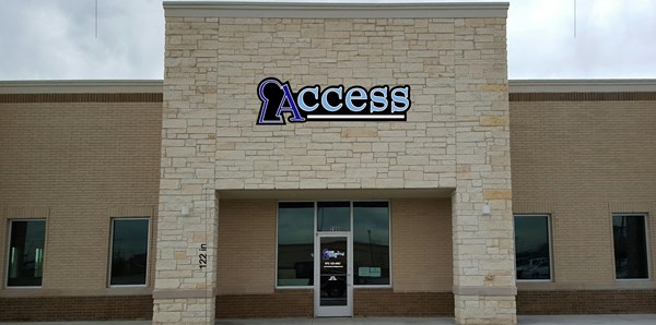 Stone building front with Access sign above entrance