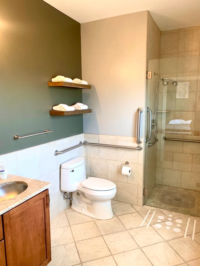 Accessible bathroom with shower and towel shelves