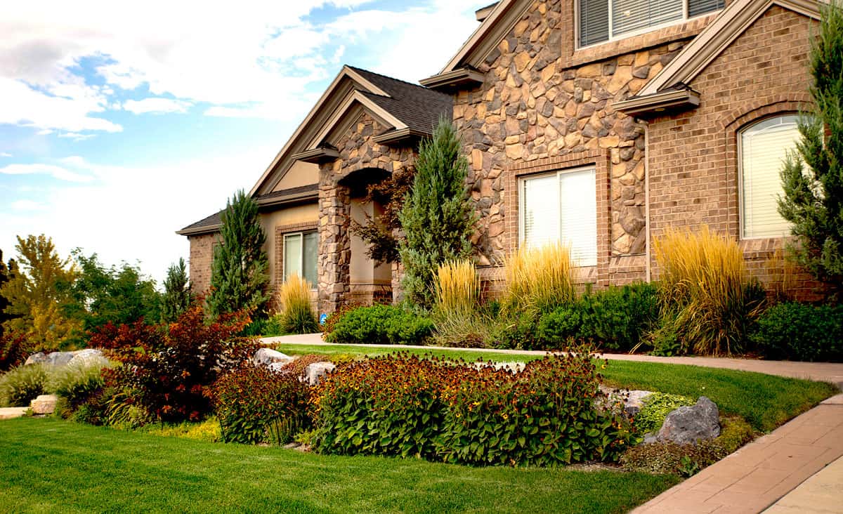 Stone-front residential facility with landscaped garden walkway.