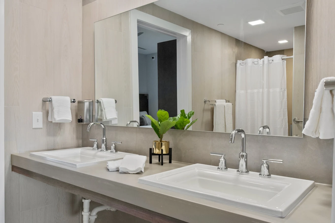 Modern bathroom with double sinks and shower