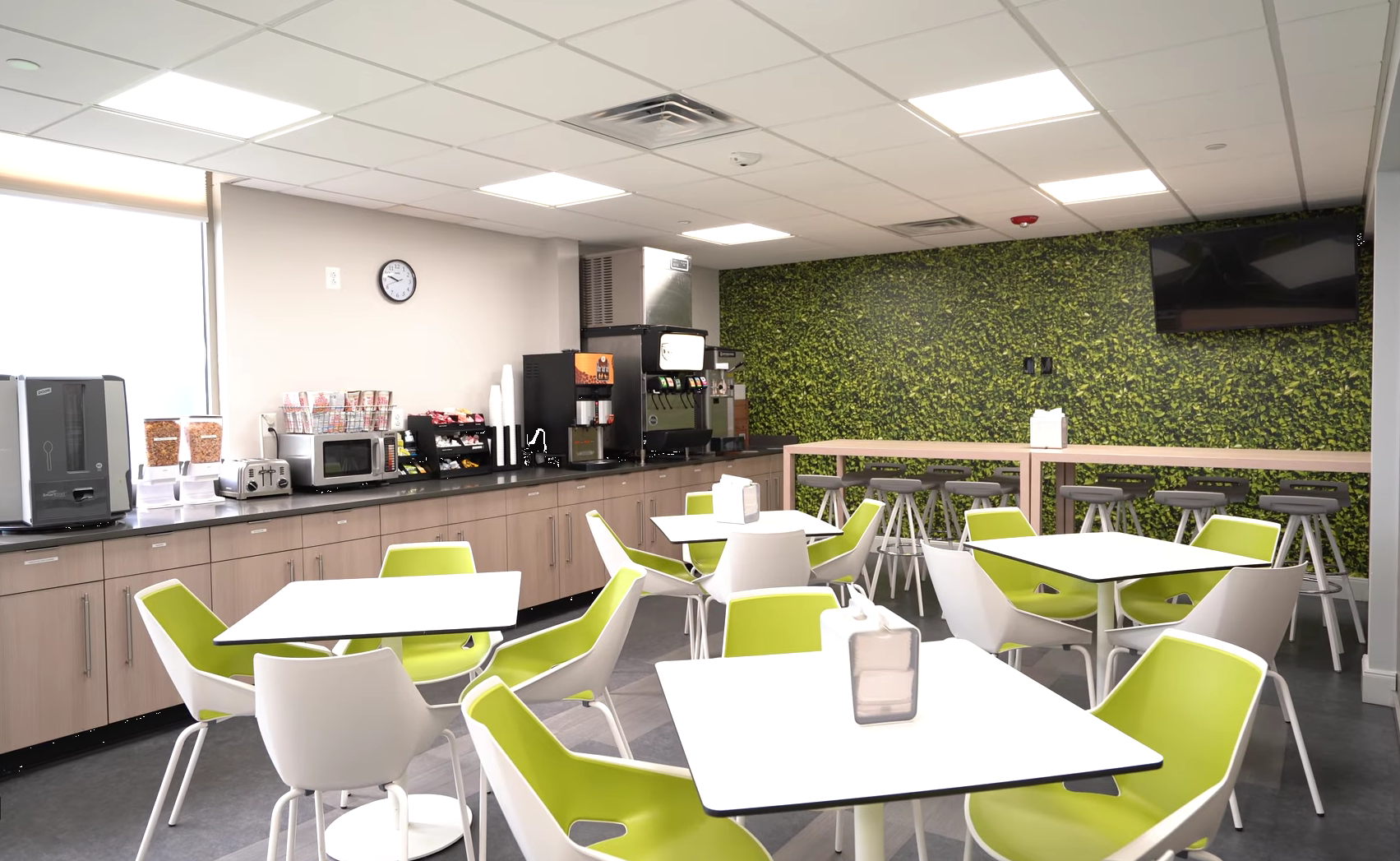 Cafeteria with tables, chairs, and beverage stations