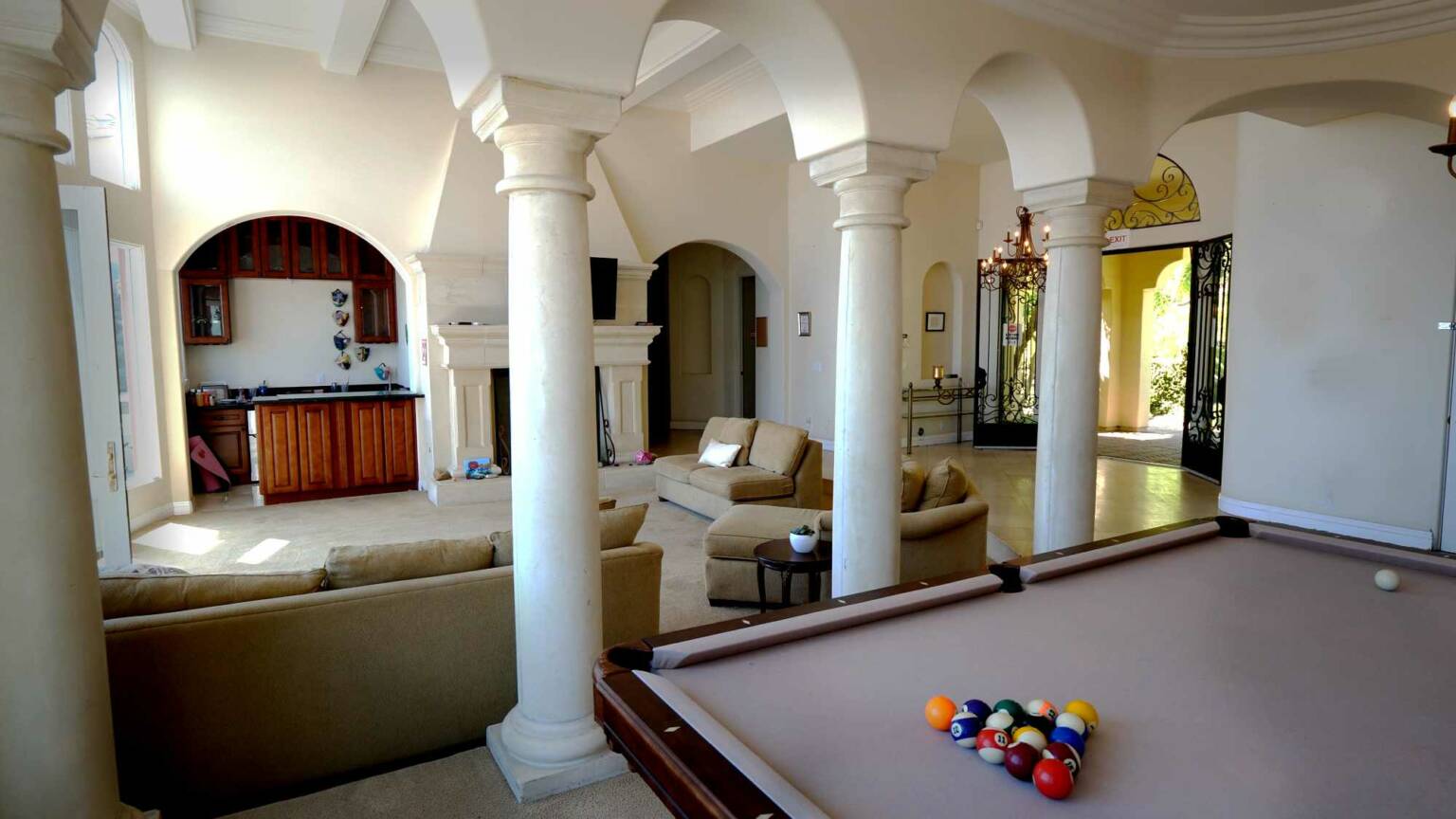Open living room with pool table and lounge seating