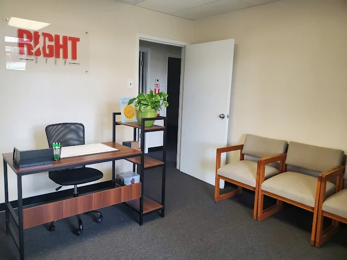 Office with desk, chairs, and Right Step logo on the wall