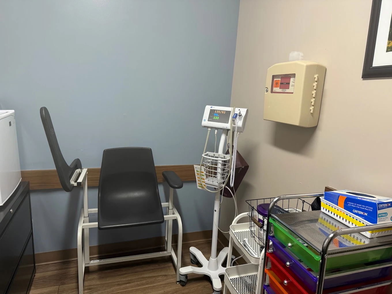 Exam room with patient chairs and medical equipment