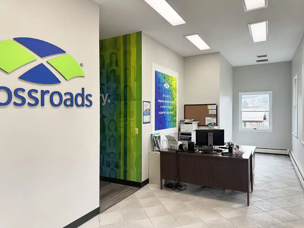 Reception desk with Crossroads logo and wall mural