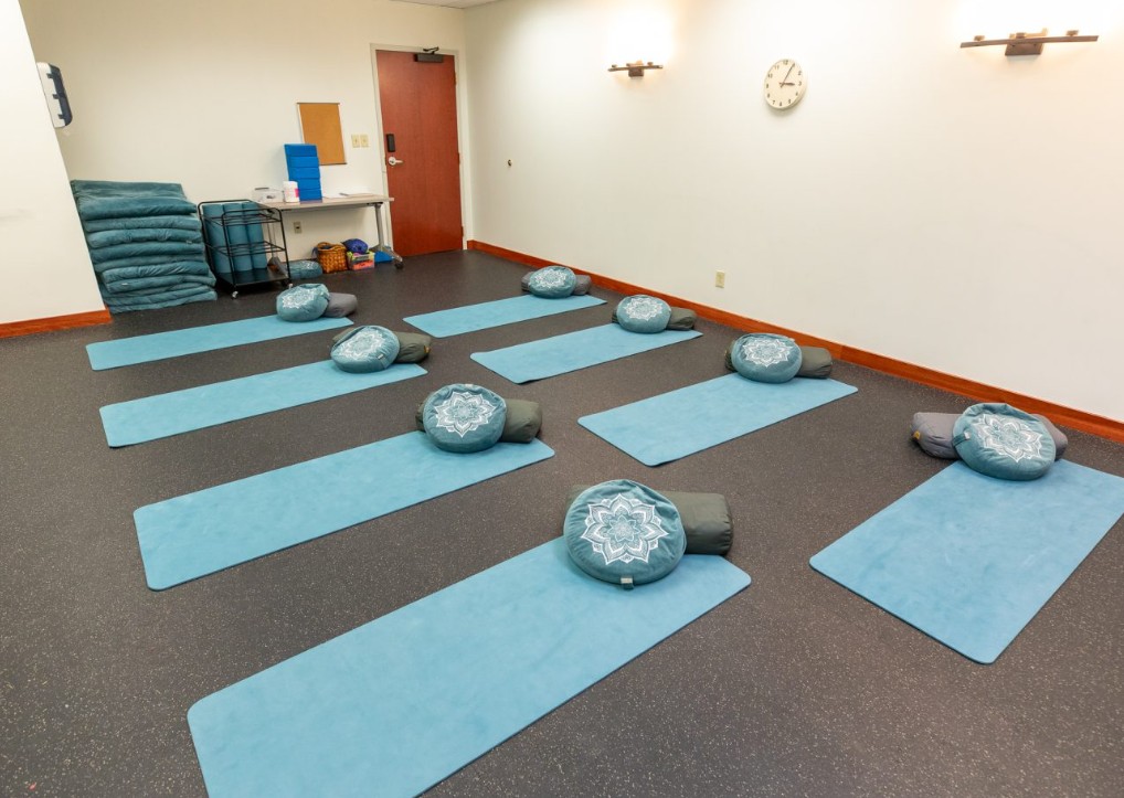 Yoga room with mats and meditation cushions