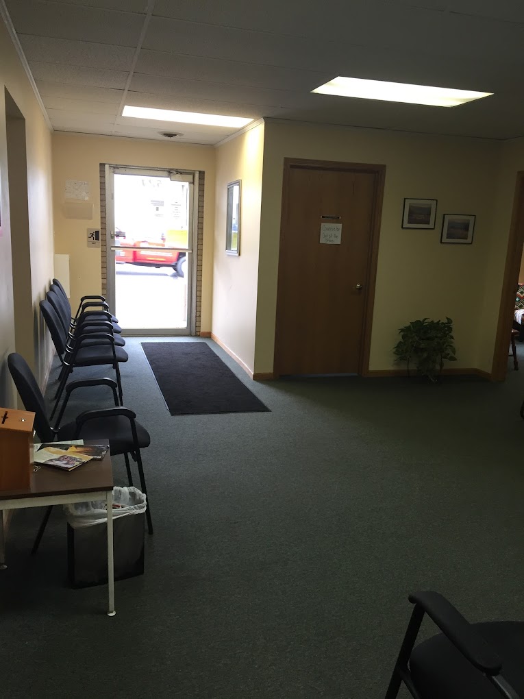 Simple waiting area with chairs and a front entrance door