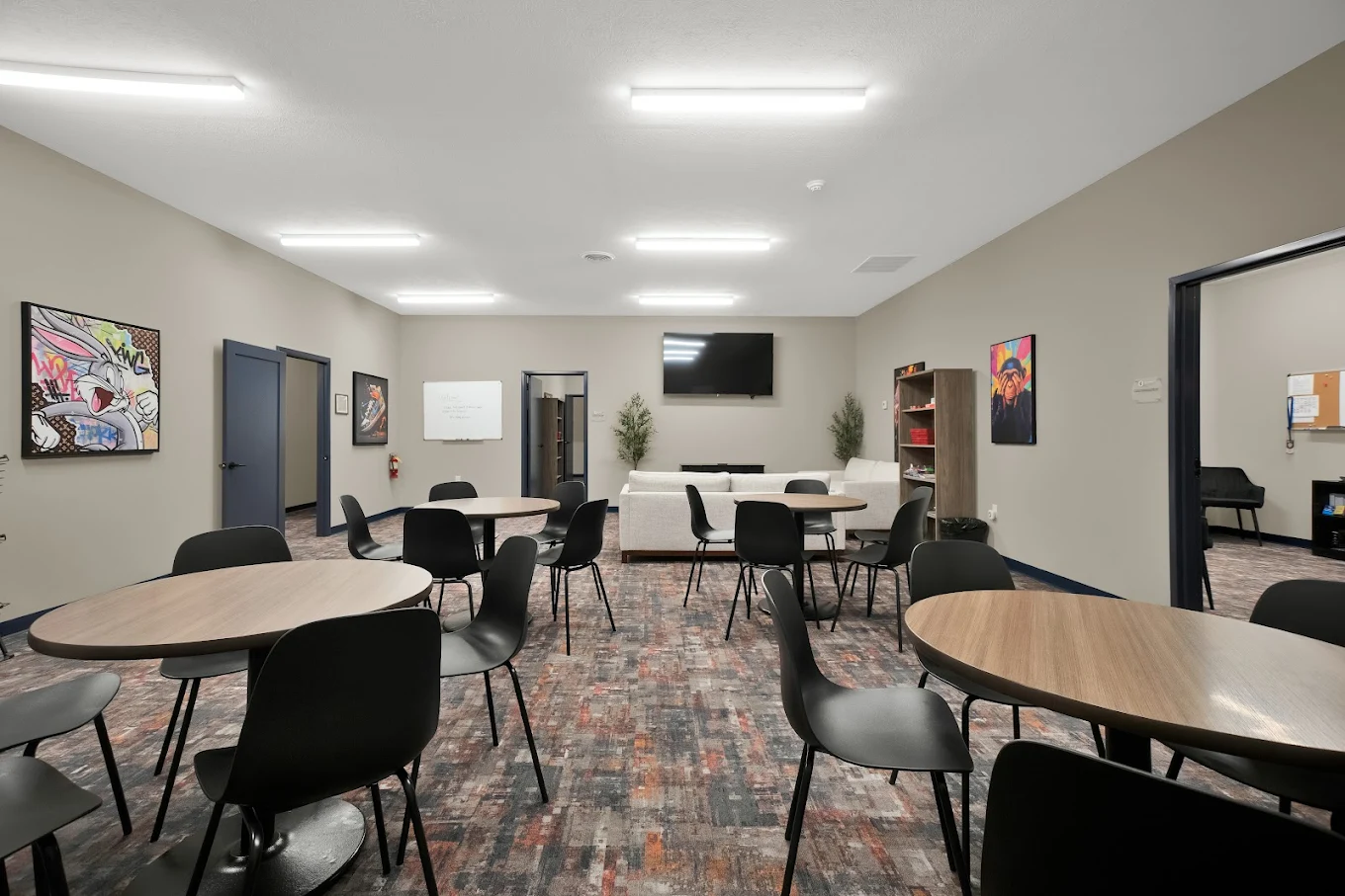 Community dining area with round tables and chairs