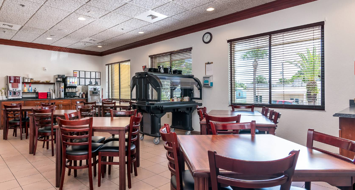 Bright cafeteria with tables and coffee station