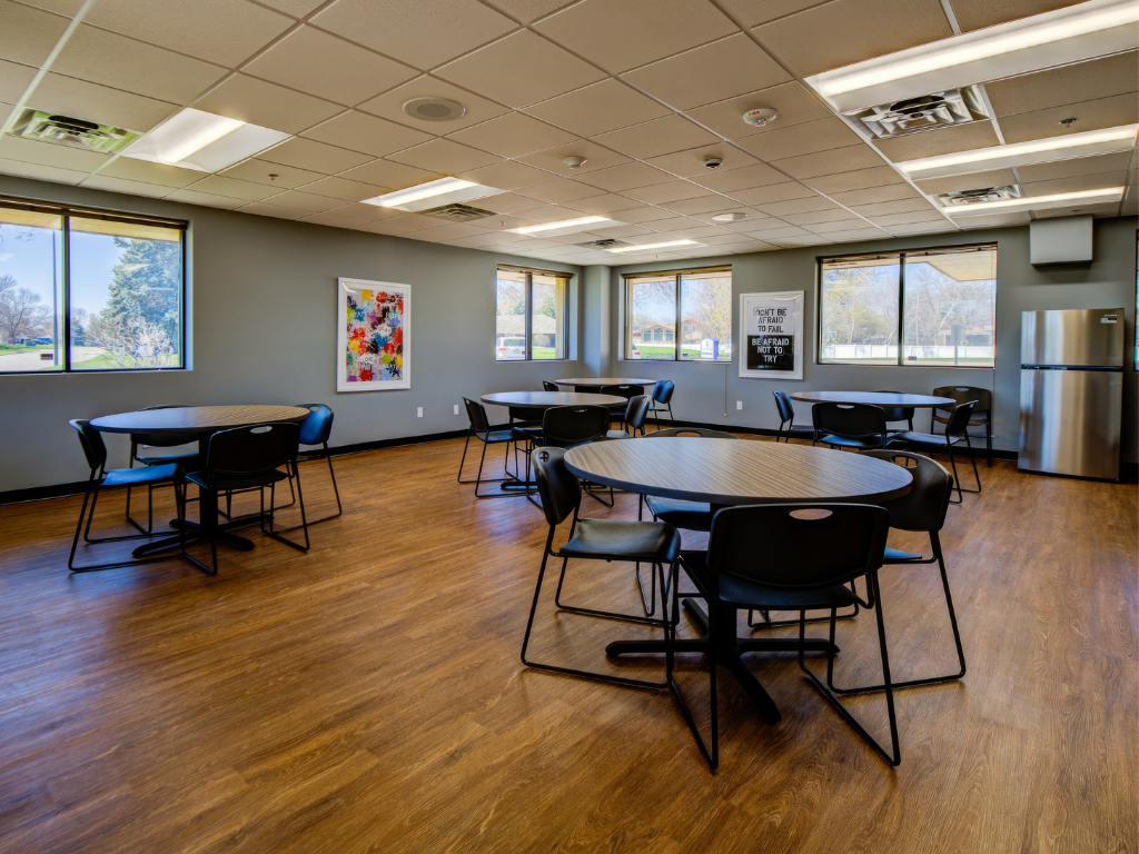 Open dining area with round tables and large windows