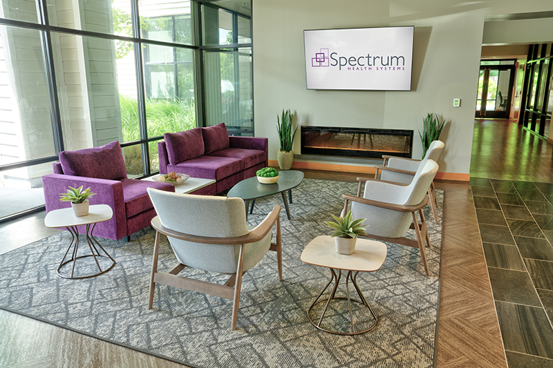 Seating area with fireplace and Spectrum Health display