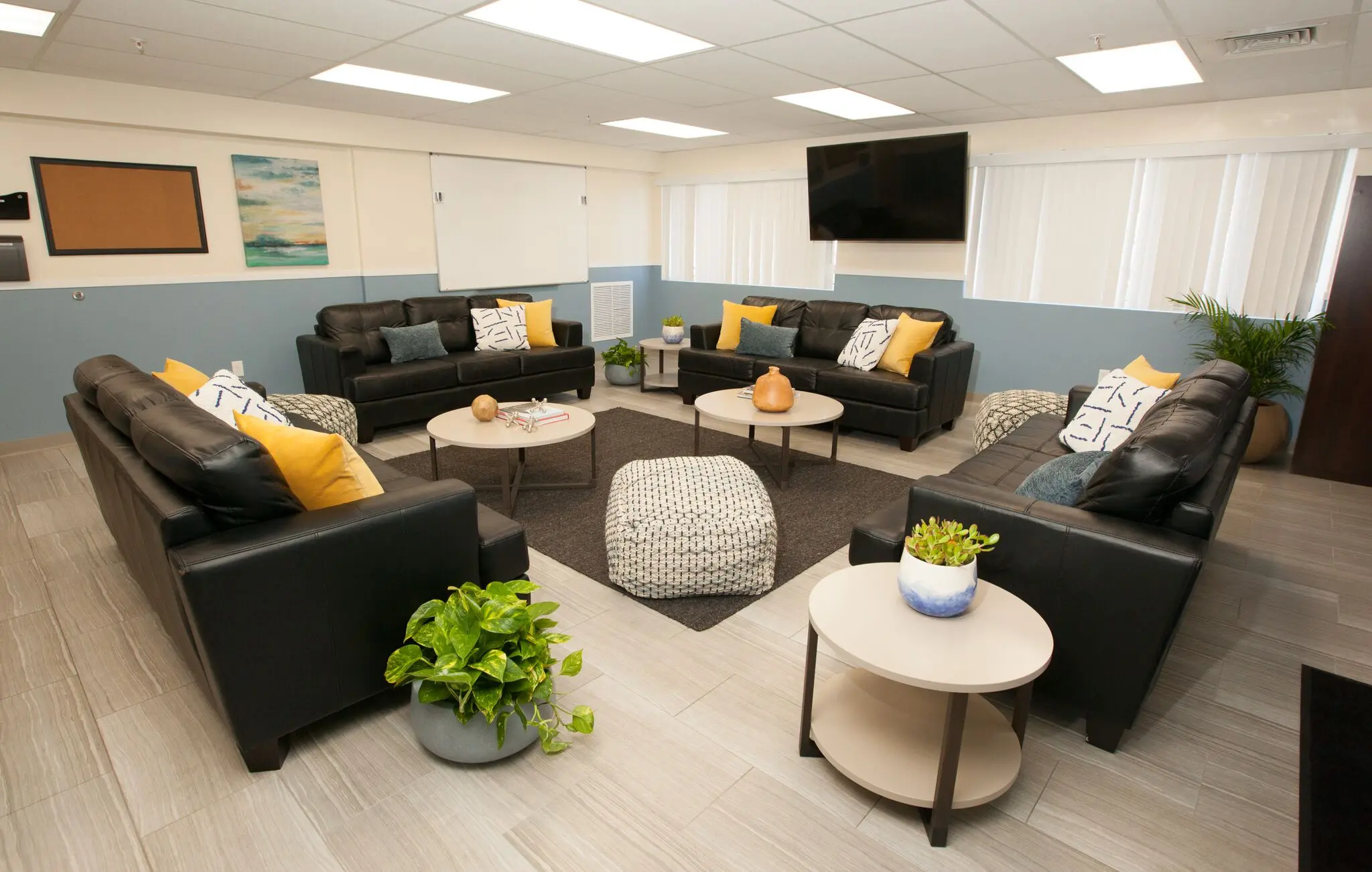 TV room with circular seating and indoor plants