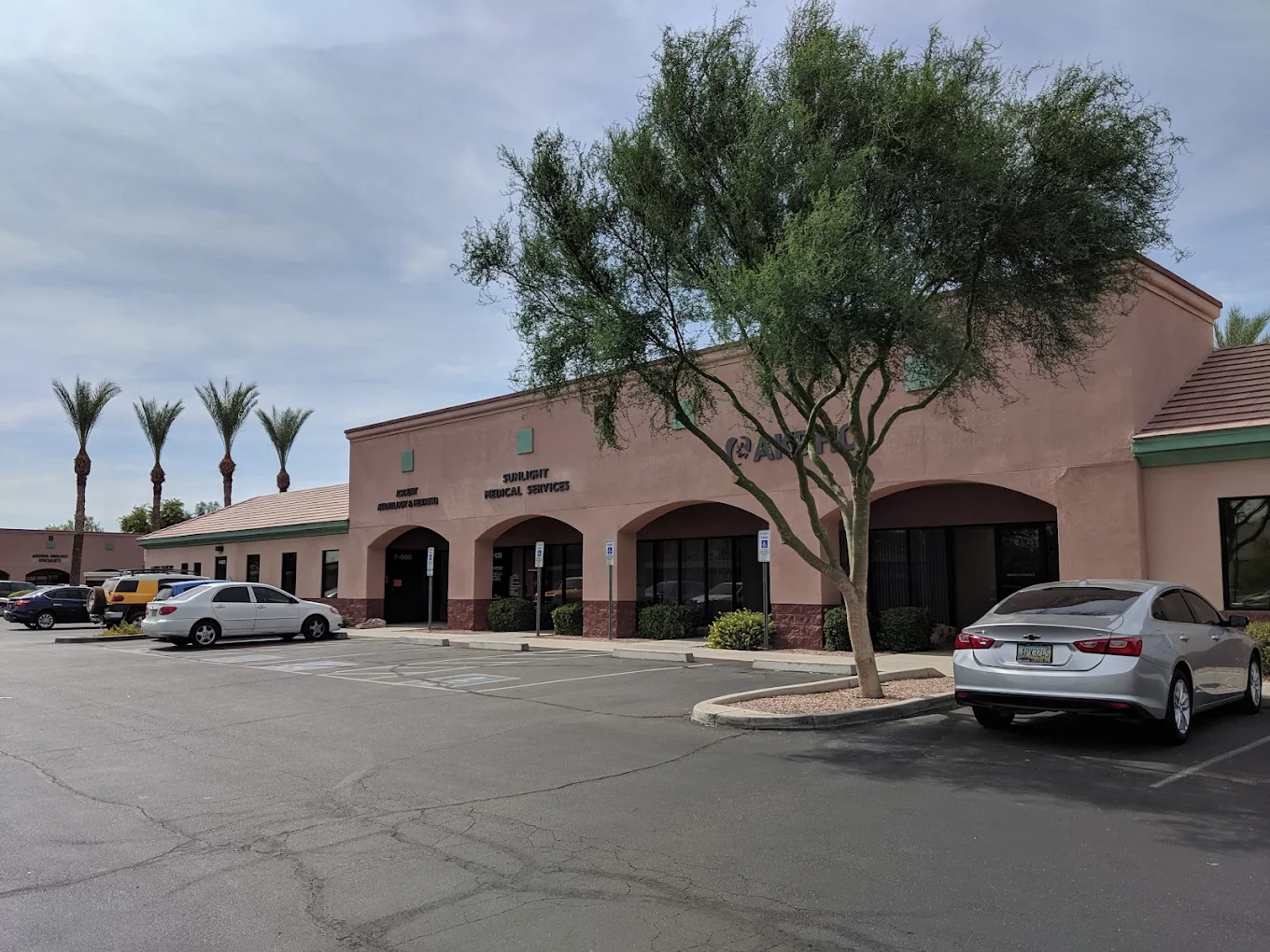 Exterior of Sunlight Medical Services with parking area