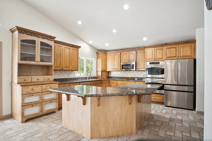 Spacious kitchen with island and wood cabinetry