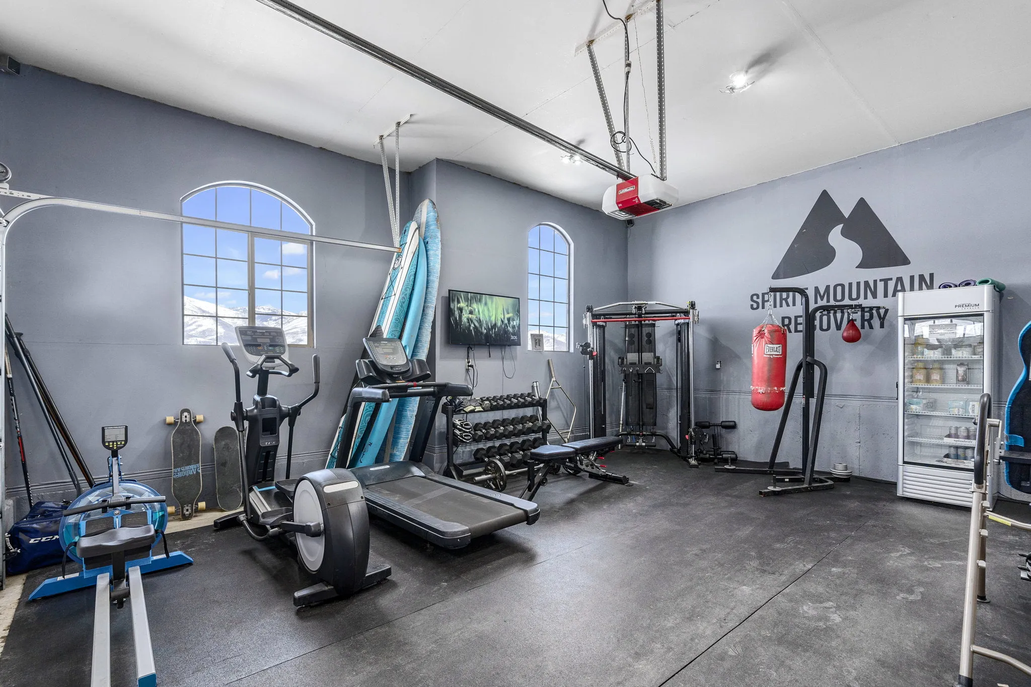 Gym with exercise machines and wall logo