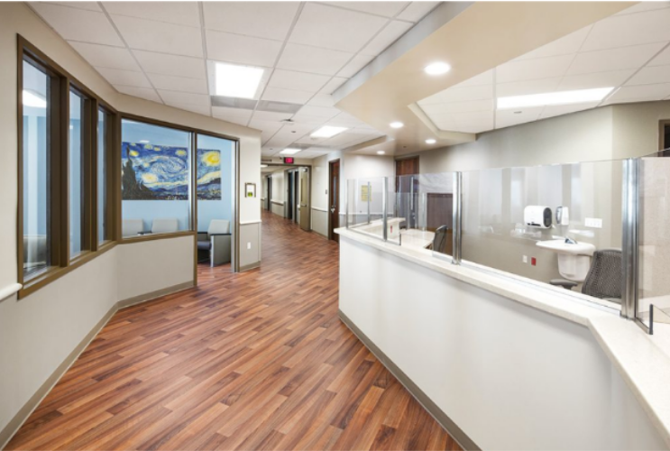 Nurses' station with reception desk and patient hallway