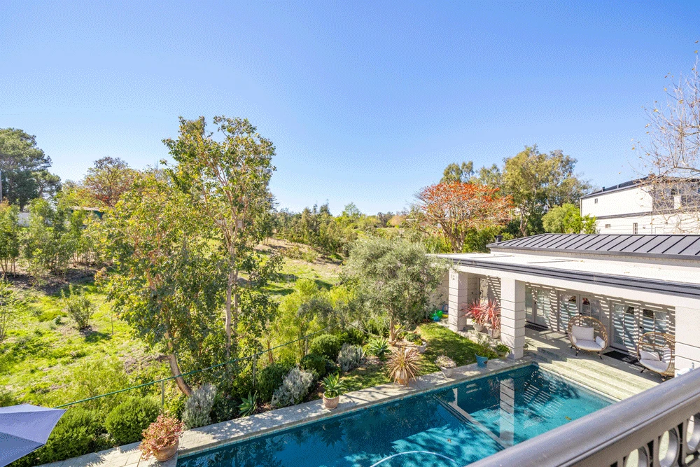 Outdoor pool with garden and lounge seating