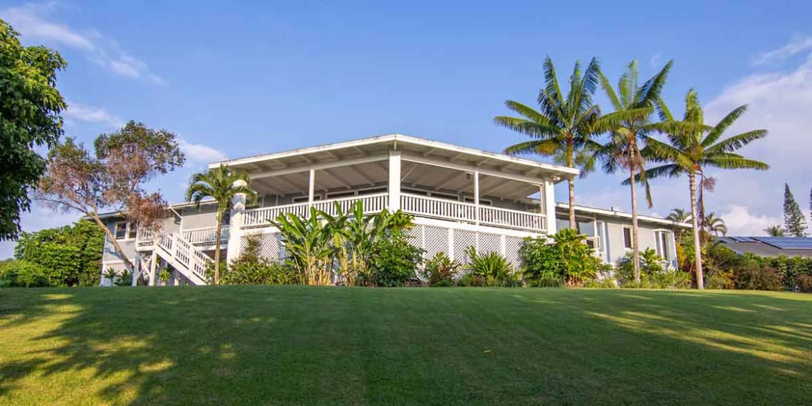 Facility facade with porch and palm trees