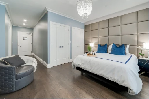 Stylish bedroom with padded headboard and chair