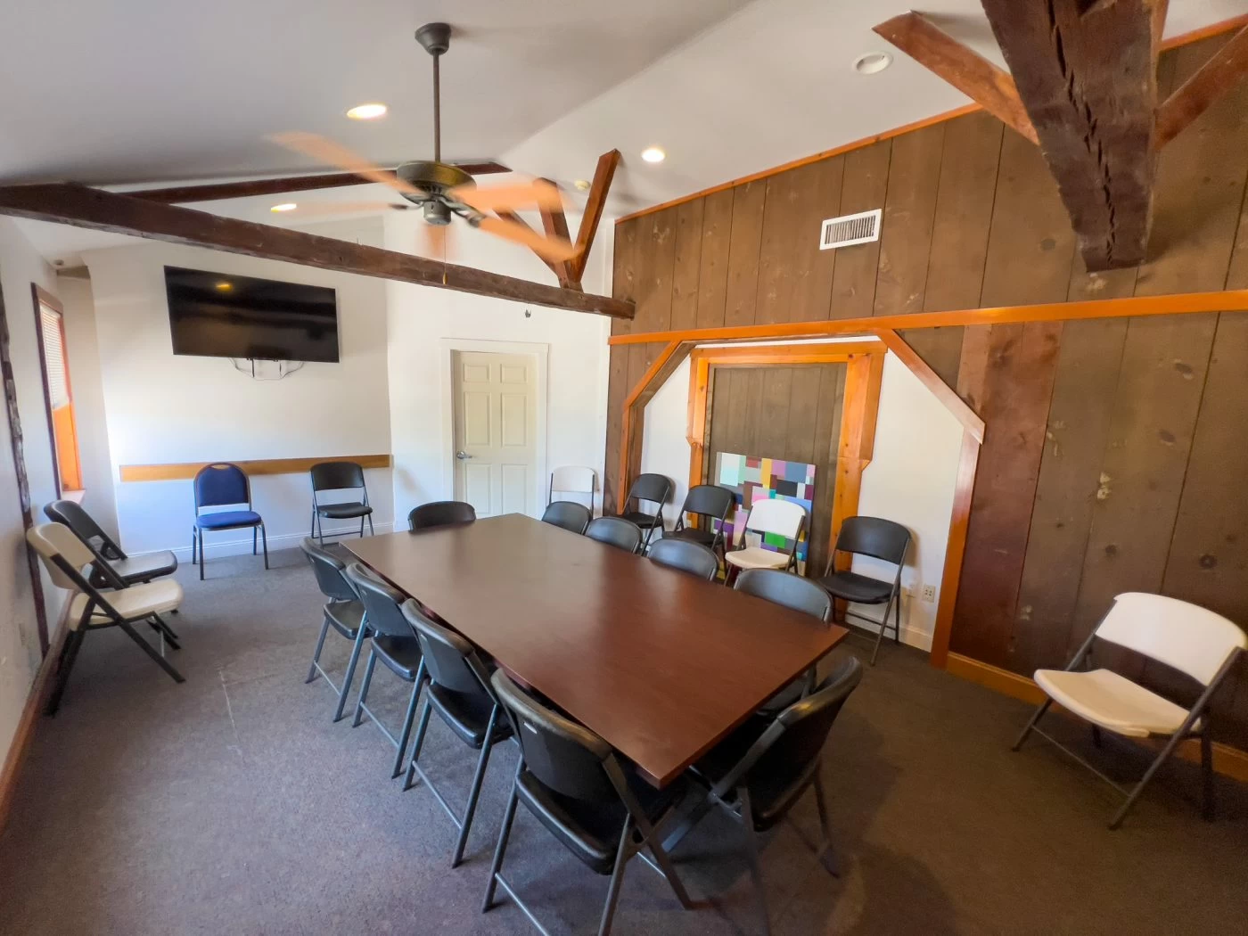 Group meeting room with table and chairs for therapy sessions at recovery center
