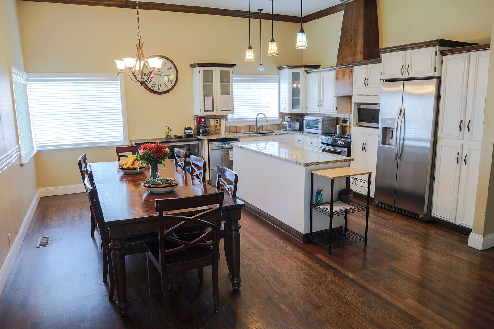 Spacious kitchen with dining table and stainless steel appliances