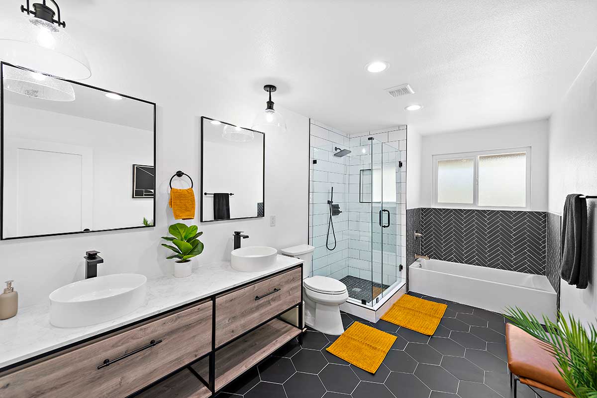 Modern bathroom with double vanity, shower, and bathtub