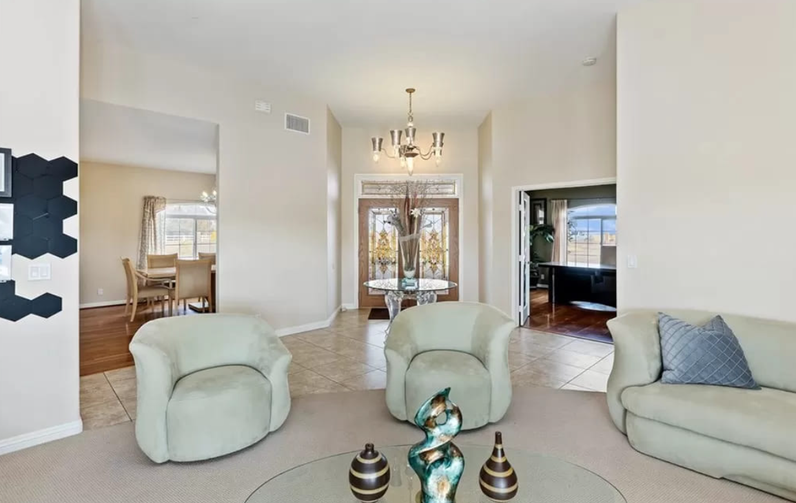 Bright lobby with modern chairs, chandelier, and glass doors