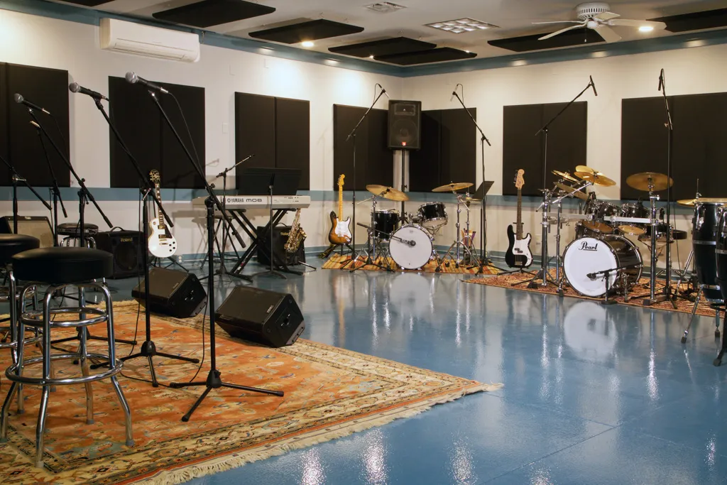 Music studio with drums, guitars, and recording gear