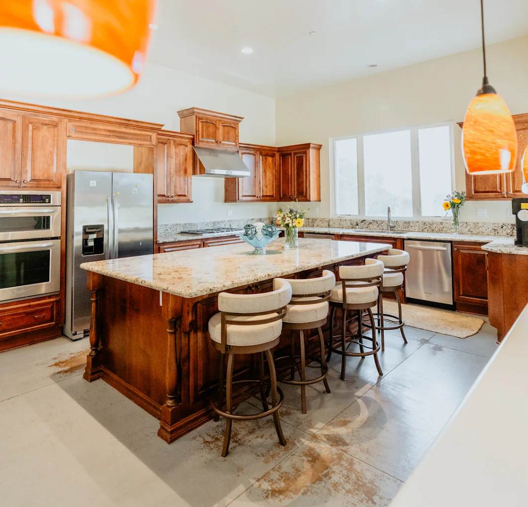 Kitchen with wood cabinets and granite island seating