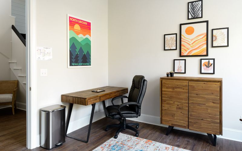 Small study space with desk, chair, and wall art