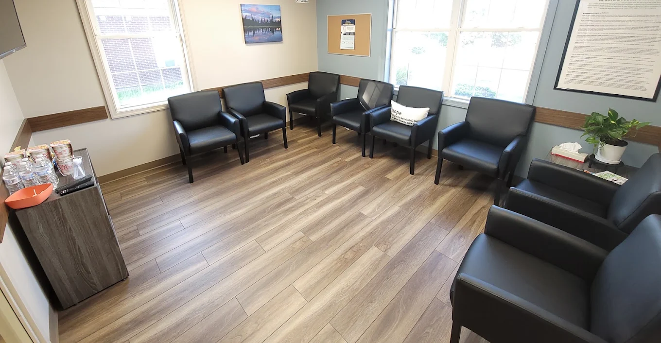 BrightView Fredericksburg waiting area with black chairs, windows, and refreshment station