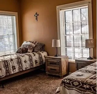Shared bedroom with twin beds and bedside furniture