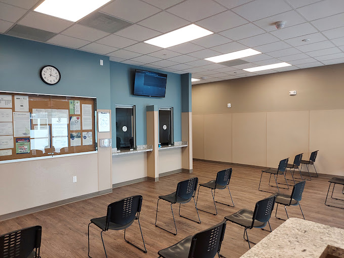 Waiting area with chairs and dispensing windows.